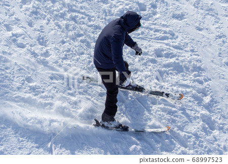 Man skiing in the snow in winter Man skiing in the snow in winter 68997523