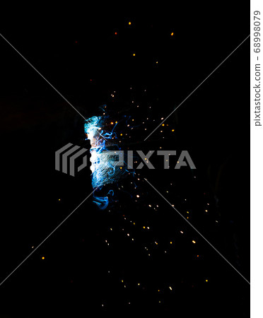 Flame of fire and sparks from welding metal at 68998079