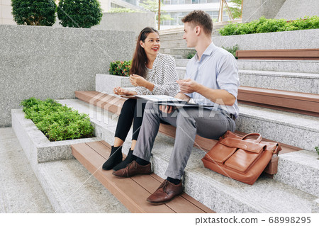 Business people discussing documents Business people discussing documents 68998295