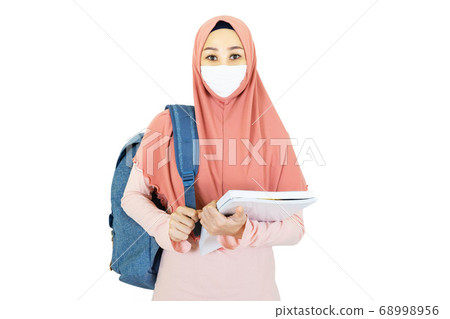 beautiful young muslim asian woman with traditional dress wearing medical face mask to go to school Under the outbreak of the virus isolated on white background,health care concept beautiful young muslim asian woman with traditional dress wearing medical face mask to go to school Under the outbreak of the virus isolated on white background,health care concept 68998956