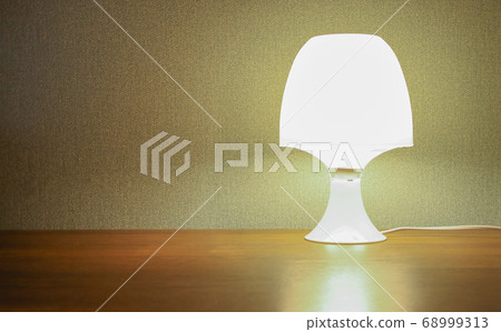 Night lamp on the table. 68999313