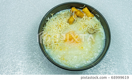 Pork Congee with Egg in bowl Pork Congee with Egg in bowl 68999619