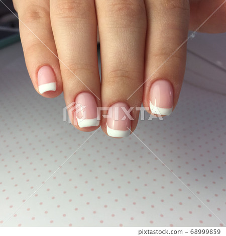 French manicure on the nails. French manicure French manicure on the nails. French manicure 68999859