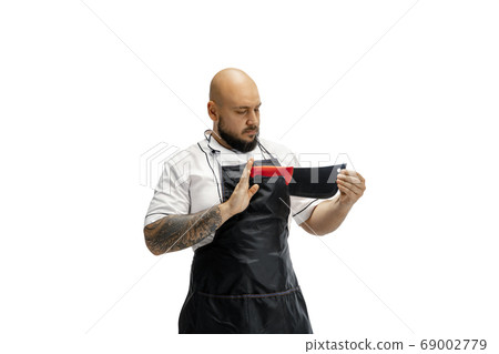 Portrait of a male chef cook, butcher isolated on a white studio background 69002779