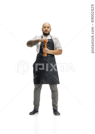 Portrait of a male chef cook, butcher isolated on a white studio background 69002829