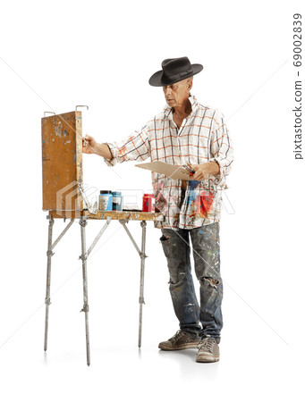 Artist, painter at work isolated on white studio background 69002839