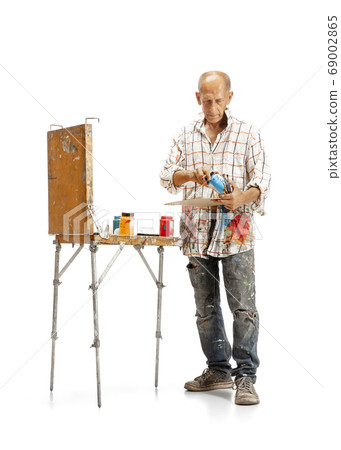 Artist, painter at work isolated on white studio background 69002865