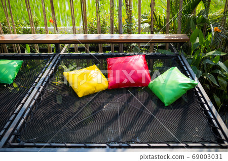 colorful pillows on net seat among nature colorful pillows on net seat among nature 69003031