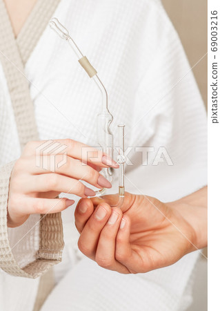 Nasal oil inhaler in hands. 69003216