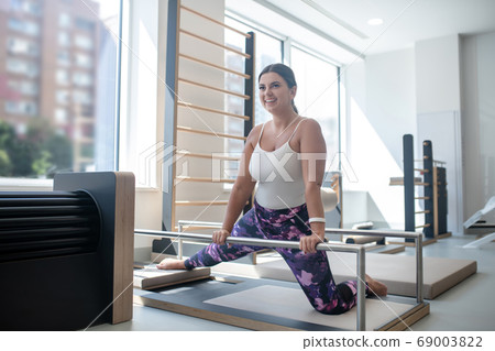 Woman stretching her muscles during the training 69003822