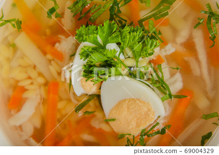 Fresh soup with vegetables, meat and eggs in a Fresh soup with vegetables, meat and eggs in a 69004329