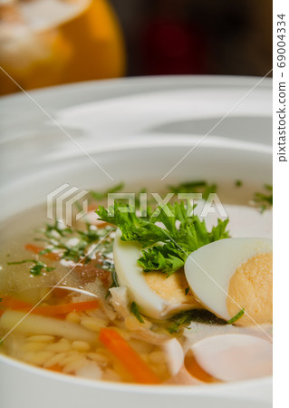 Fresh soup with vegetables, meat and eggs in a Fresh soup with vegetables, meat and eggs in a 69004334