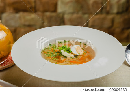 Fresh soup with vegetables, meat and eggs in a 69004383