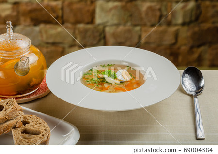 Fresh soup with vegetables, meat and eggs in a 69004384