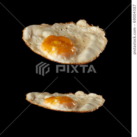 fried chicken egg with yolk isolated on black 69004387