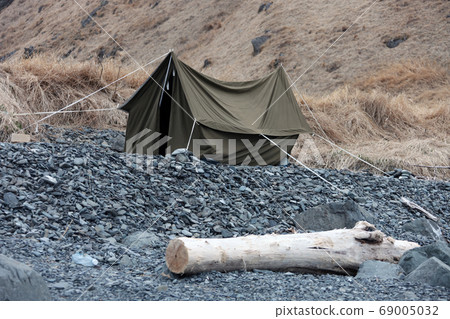 Canvas tent on the rocky shore Canvas tent on the rocky shore 69005032