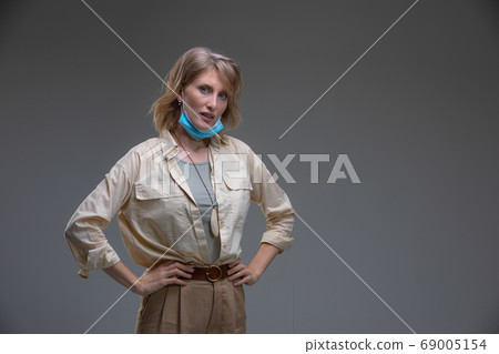 Blond woman take off her surgical mask Blond woman take off her surgical mask 69005154