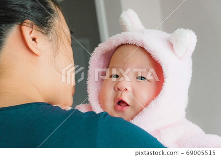 A newborn Asian baby boy in the mother's embrace, A newborn Asian baby boy in the mother's embrace, 69005515