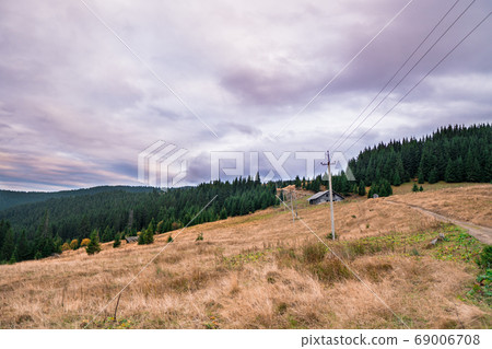 Traditional mountain house on field of dried grass Traditional mountain house on field of dried grass 69006708