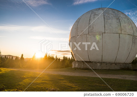 Dramatic sunrise over uniquely designed old radar 69006720