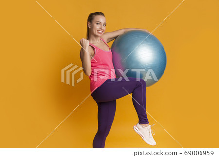 Happy Young Woman Celebrating Sport Success With Fitness Ball Happy Young Woman Celebrating Sport Success With Fitness Ball 69006959