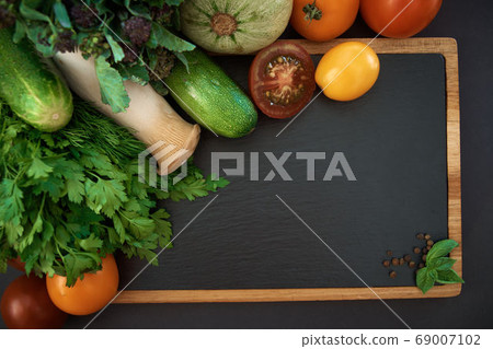 Vegetables dark background with copy space. Healthy meal. Menu, price background. Vegetables on black chalkboard. 69007102