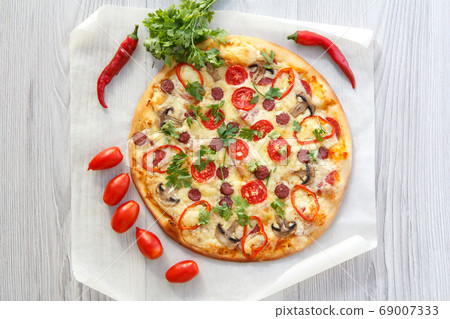 Fresh homemade pizza with tomatoes, salami, cheese 69007333