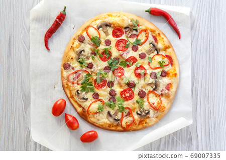 Fresh homemade pizza with tomatoes, salami, cheese 69007335