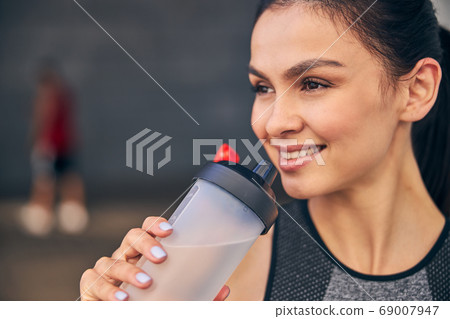 Portrait of pleased girl being deep in thoughts Portrait of pleased girl being deep in thoughts 69007947