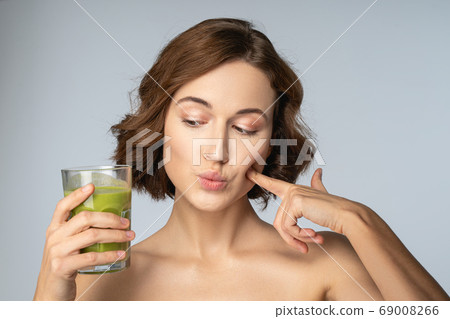Beautiful young female with a green smoothie Beautiful young female with a green smoothie 69008266