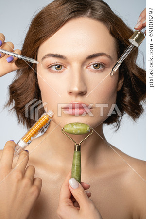 Serene woman undergoing a skin rejuvenation treatment Serene woman undergoing a skin rejuvenation treatment 69008292