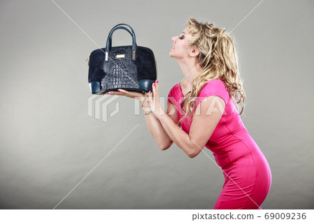 Elegant woman buyer with dep blue bag. Elegant woman buyer with dep blue bag. 69009236