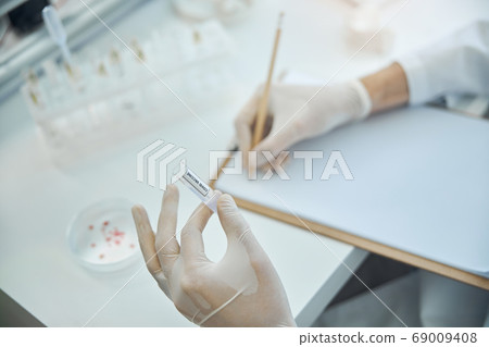 Infectious disease doctor working on coronavirus treatment 69009408