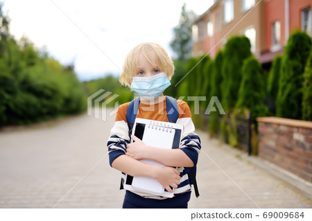 Child wearing face mask going at reopen school Child wearing face mask going at reopen school 69009684