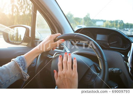 Women's hands on the wheel. Cars interior Women's hands on the wheel. Cars interior 69009793