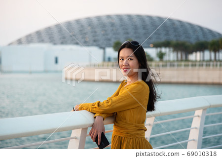 Woman visiting Louvre in Abu Dhabi United Arab Emirates Woman visiting Louvre in Abu Dhabi United Arab Emirates 69010318