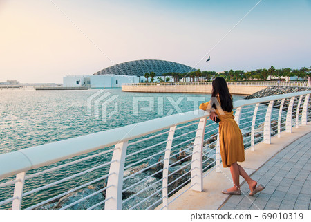 Woman visiting Louvre in Abu Dhabi United Arab Emirates 69010319