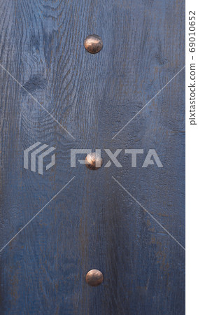 Modern abstract closeup of dark deep blue wooden background with metallic brass rivets for your design. Textured background. Retro color effect. Abstract dark background. Modern abstract closeup of dark deep blue wooden background with metallic brass rivets for your design. Textured background. Retro color effect. Abstract dark background. 69010652