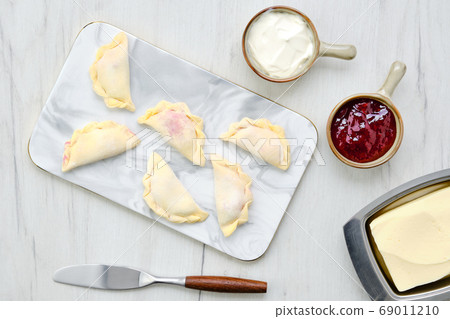 Top view of cherry vareniki on marble serving 69011210