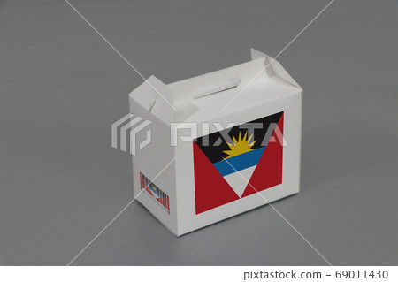 Antigua and Barbuda flag on white box with barcode and the color of nation flag.  69011430