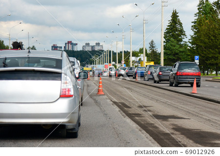 Daytime road repair of a lane in a city with Daytime road repair of a lane in a city with 69012926