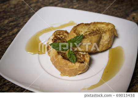 homemade french toast and presented on a white homemade french toast and presented on a white 69013438
