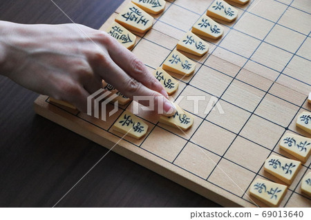 Shogi board and hand to hit the piece 69013640