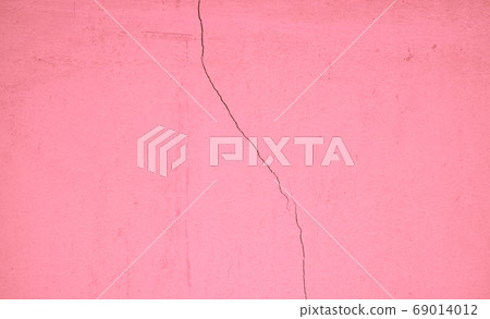 Pastel pink concrete wall surface, weathered with cracks and scratches, abstract texture for background 69014012