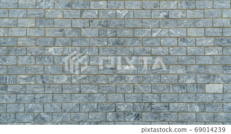 wall is lined with gray marble tiles. 69014239