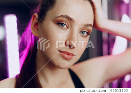 Portrait of a young sporty caucasian woman training in a fitness club 69015303