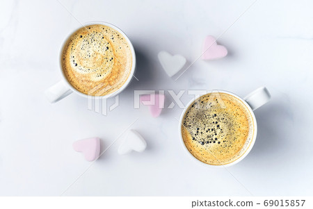 Romantic desk top with two cups of coffee and pink 69015857