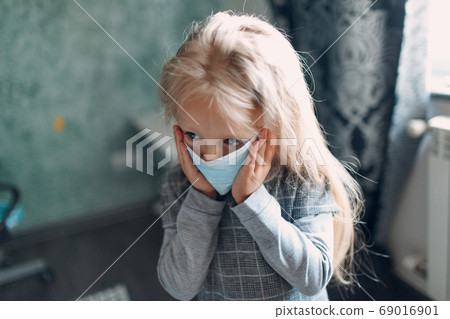 Little girl dressing uniform and putting face mask preparation back to school Little girl dressing uniform and putting face mask preparation back to school 69016901
