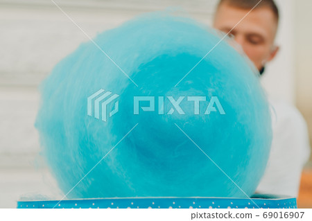 Cotton Candy floss machine making blue candyfloss outdoor Cotton Candy floss machine making blue candyfloss outdoor 69016907