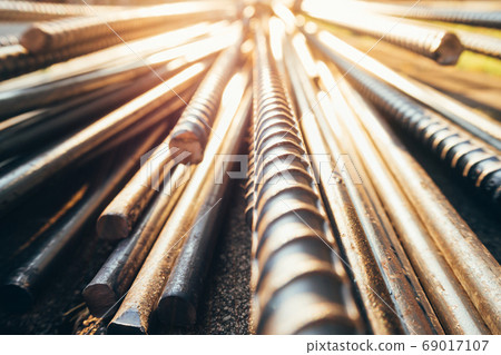 steel bar or steel reinforcement bar in construction site with sunbeam. steel bar or steel reinforcement bar in construction site with sunbeam. 69017107